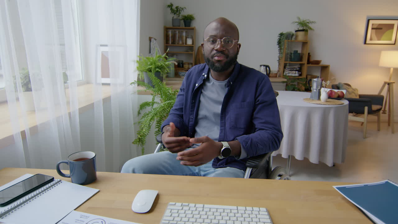 Black Man in Wheelchair Speaking on Camera at Home