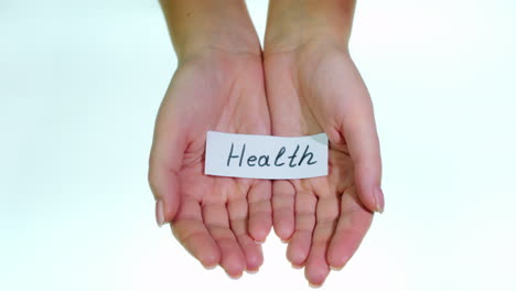 note health in female hands on a white background