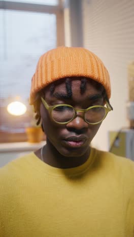 young man in orange hat and yellow shirt