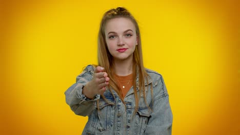 friendly girl outstretching hand to camera, offering handshake, greeting with kind smile, welcoming