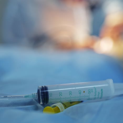 instrumental surgical in operating room. plastic syringe on the table