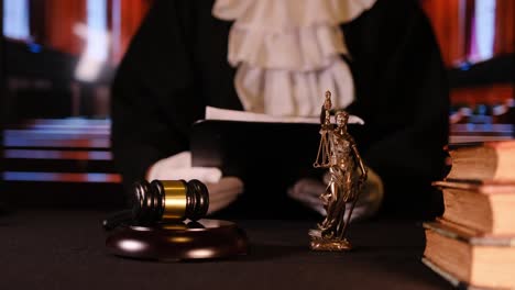 the symbolic representation of justice within a courtroom setting includes the presence of a gavel and lady justice