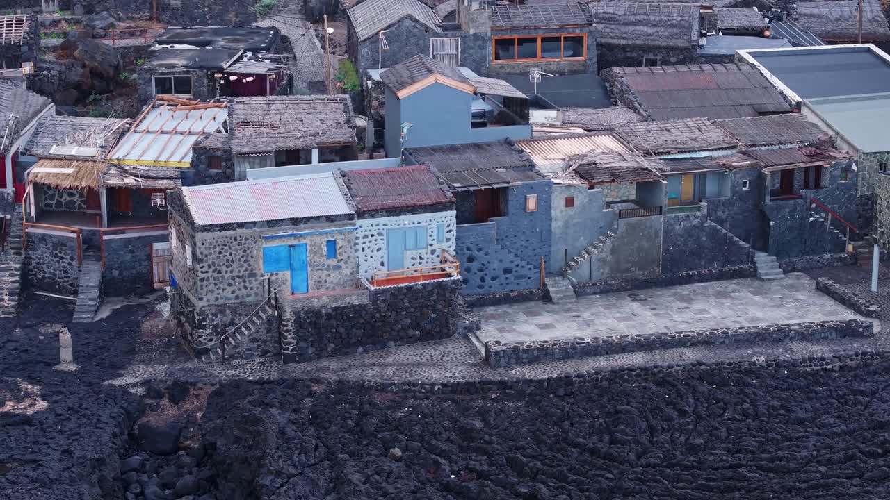 Handmade rustic homes, thatched roofs in El Hierro fishing village from above