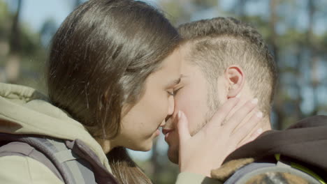 closeup shot of romantic young couple kissing outdoors