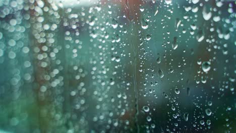 glass window in rainy weather with raindrops. falling drops. wet window with drops and white dots. close-up.
