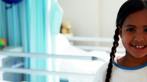 girl smiling at camera in hospital