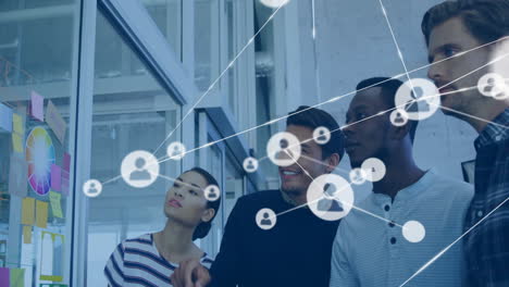 Animation of network of connections with people icons over diverse business people in office