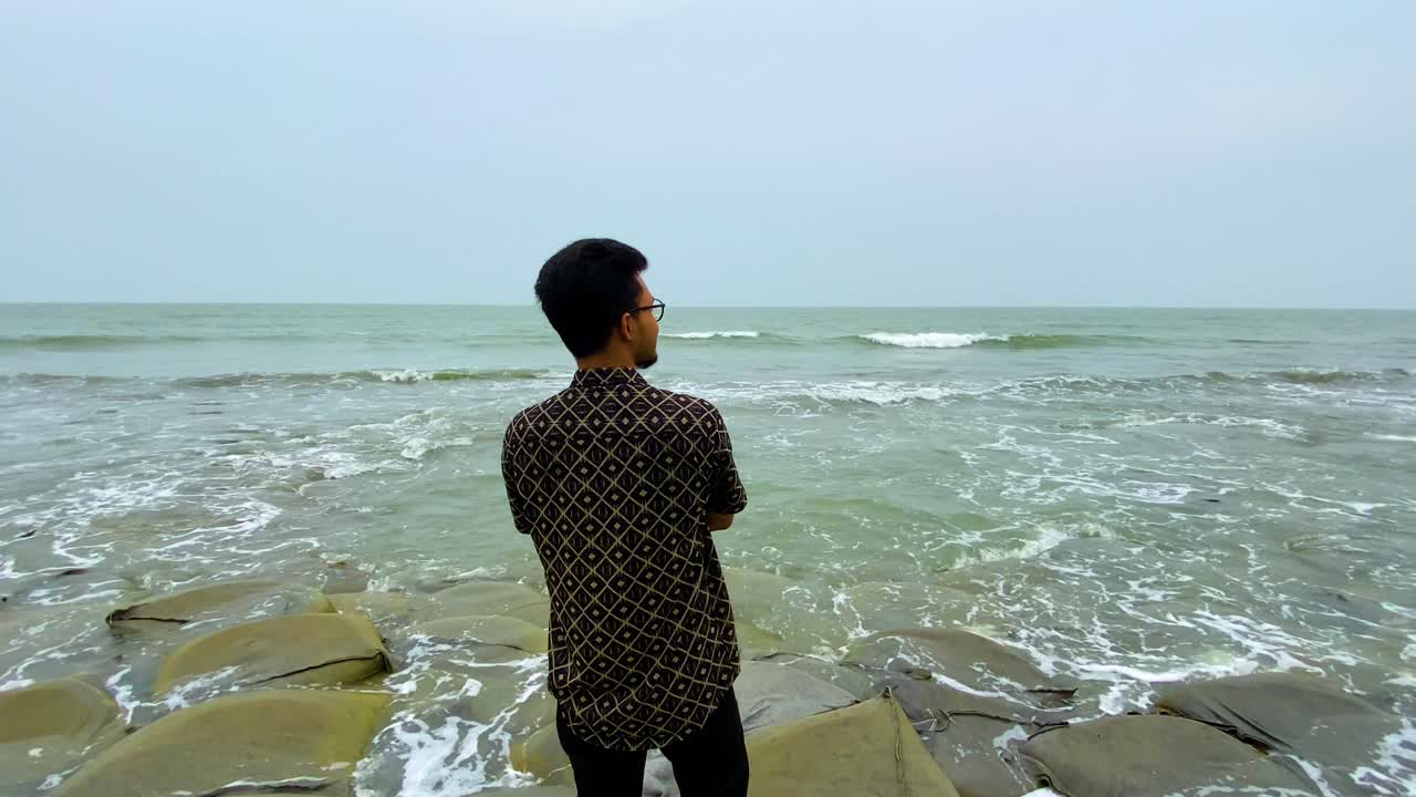 Man Standing By The Sea Shore In Kuakata Beach In Bangladesh - Wide Shot