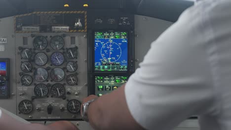 Pilots-touching-digital-interface-screen-in-cockpit-dashboard-of-airplane