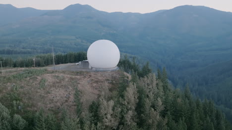 Close-aerial-footage-of-a-globe-radio-station-on-top-of-a-mountain-in-the-Cascade-Mountains