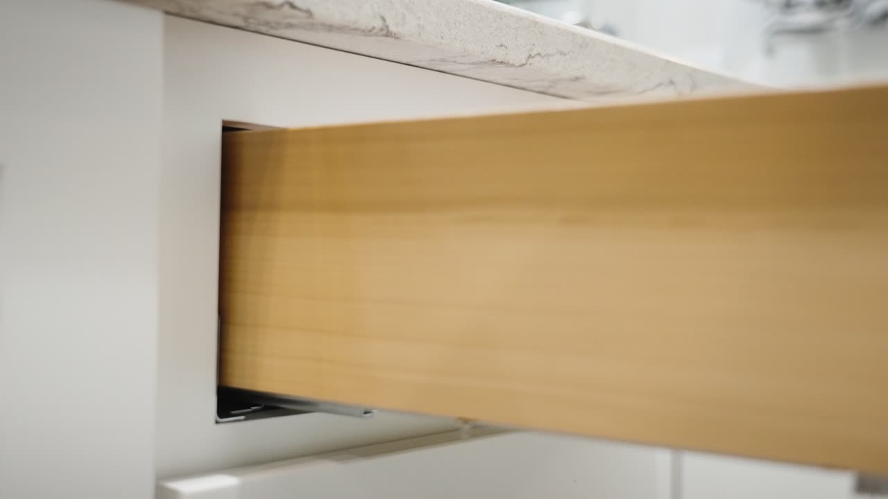 Closing a newly installed set of drawers with soft close features.