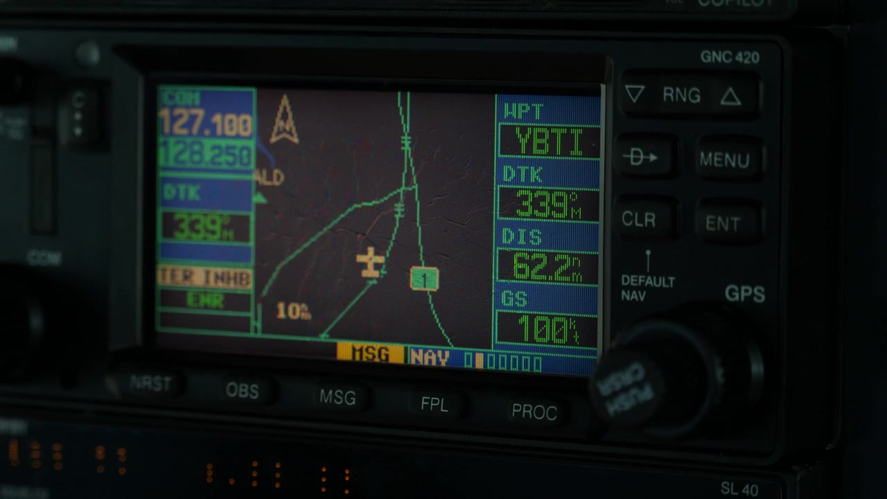 Pilot adjusting navigation instrument in light plane