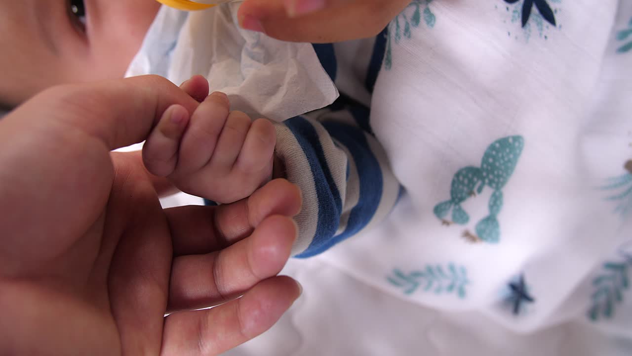 Baby Holding Mother'S Finger While Drinking Milk From A Bottle, Video In 4K