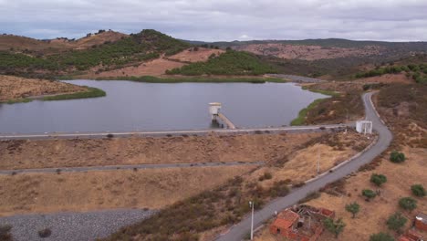 aerial towards water reservoir in rural landscape, alentejo