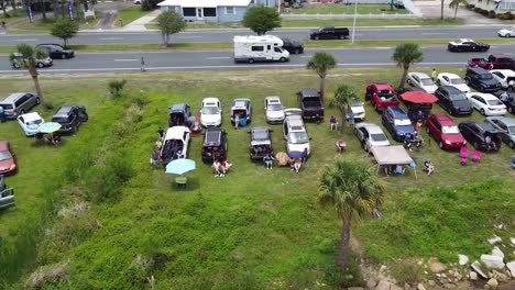 cars and trucks lined up on the coast awaiting the delayed historic spacex-nasa falcon heavy launch.