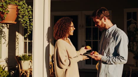 couple sharing treats on a sunny porch