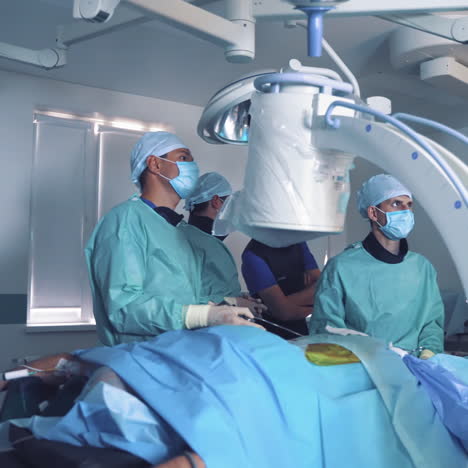 group of doctors perform an operation to a patient. surgeons in medical uniform and masks working in the operating room. neurosurgery.