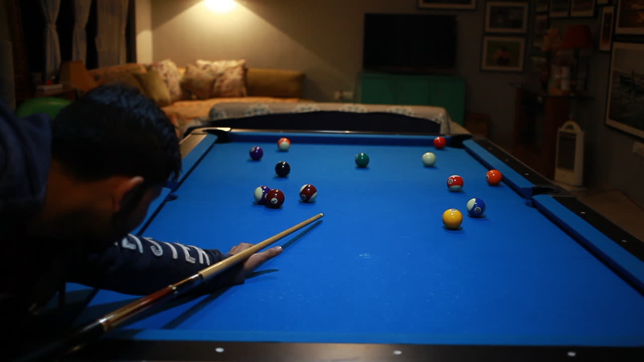 man enjoy to play cue sport or billiard game