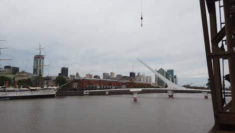puerto madero women's bridge at buenos aires river landscape, panning view
