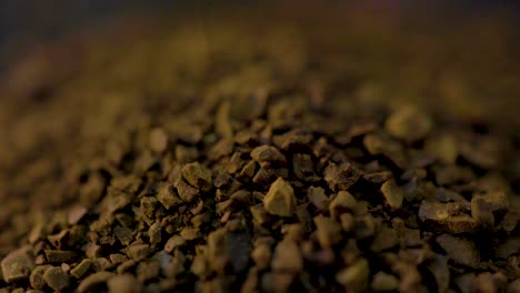 macro-shot-of-coffee-grinds-being-pour-on-the-kitchen-table