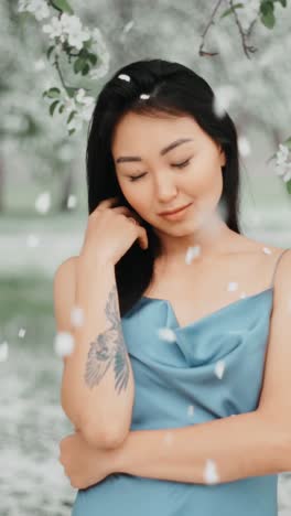 woman in a blue dress amongst spring flowers