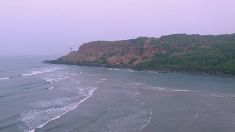 aerial view of a serene beach and cliff coastline