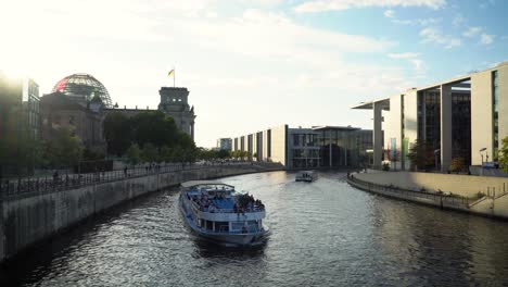 famous regierungsviertel of berlin city with boats on spree river