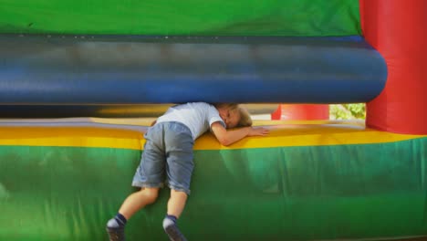 boy coming out from bouncing castle 4k