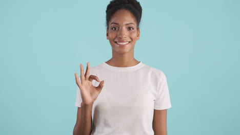 smiling woman giving ok sign