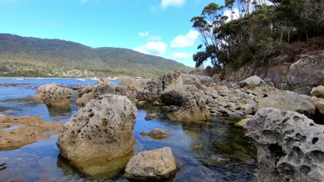 Port-Arthur,-Tasmania,-Australia---12-March-2019:-View-of-the-rocks-boats-and-yachts-at-Pirates-Bay-in-Tasmania