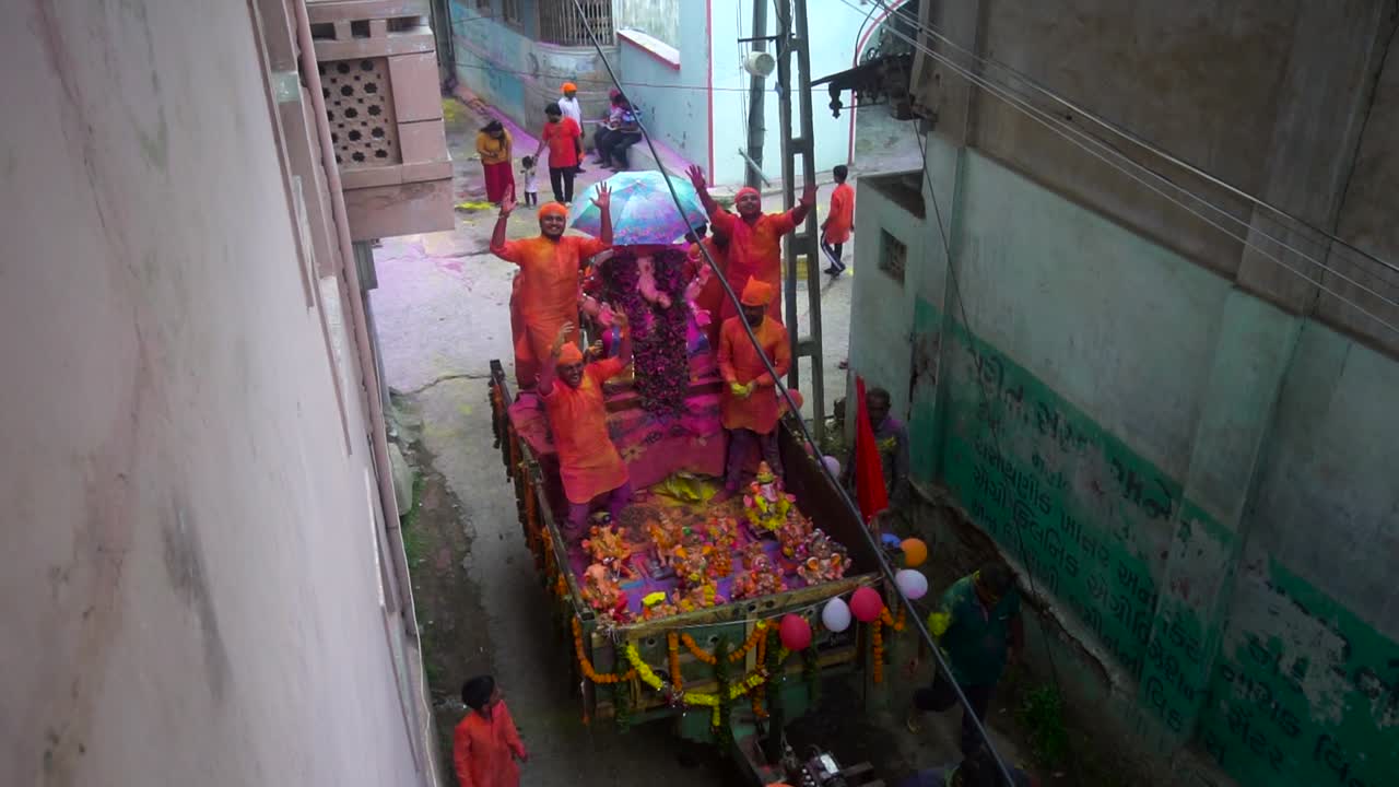 People dancing in Visarjan in Ganesh Festival of India. In Ganesh festival people say good bye to lord ganesha for next year. People celebrating ganesh festival with colors and joy