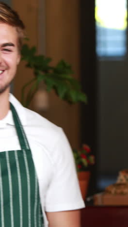 smiling waiter and waitress gesturing thumbs up