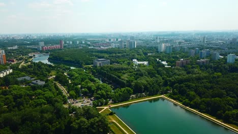 aerial view of city park with river and buildings