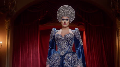 drag queen in elaborate blue gown and ornate headpiece