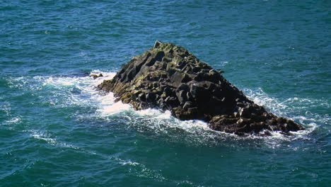 slow motion footage of sea waves on coast line with cliffs and rocks in arnarstapi village in iceland on snaefellsnes peninsula