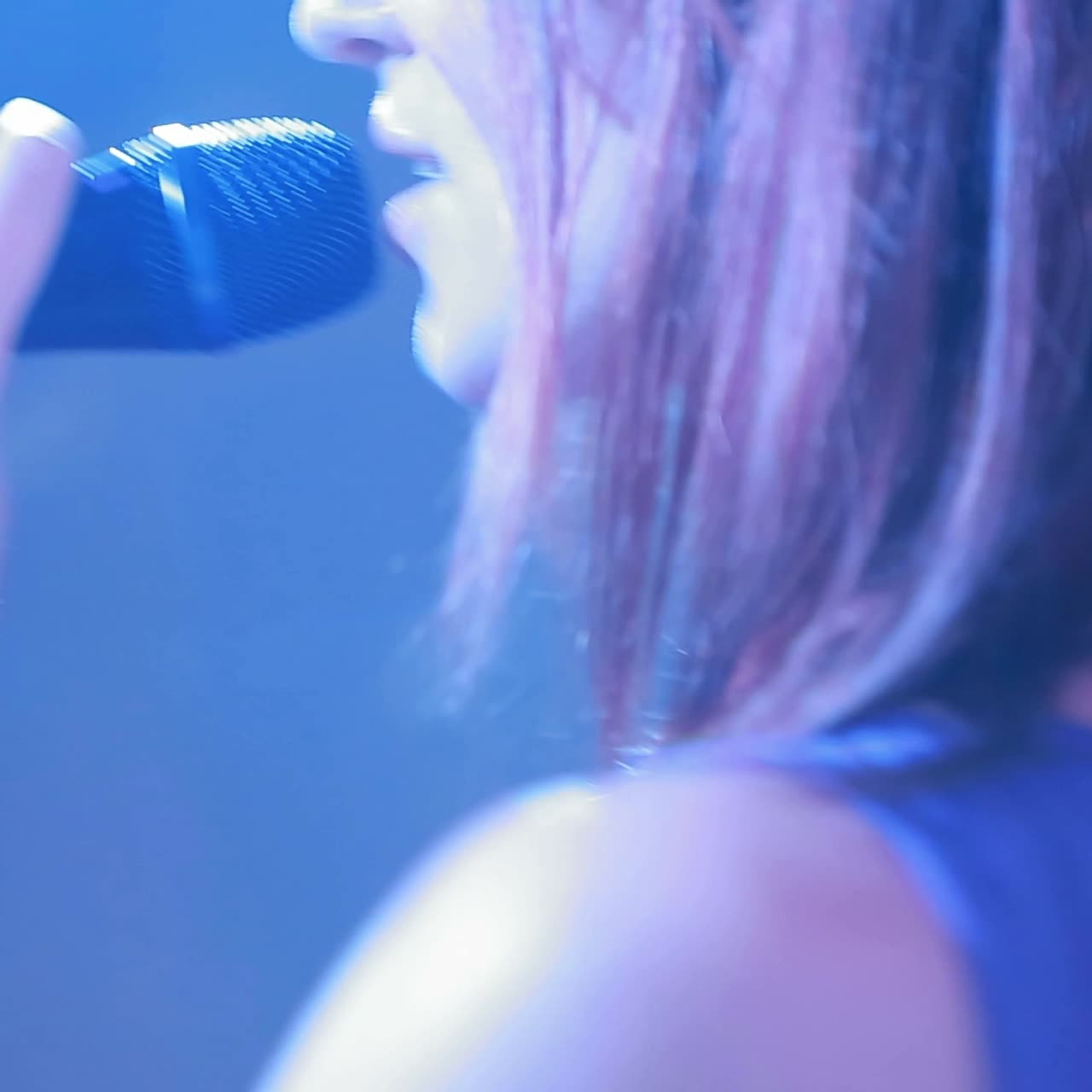 Female singer with a microphone on stage