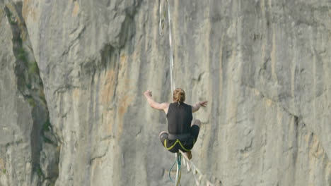 athlete on high line slack line over cliff in germany