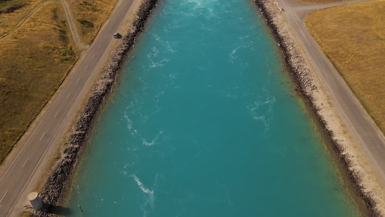 Aerial establishing shot of hydro canal on New Zealand's south Island