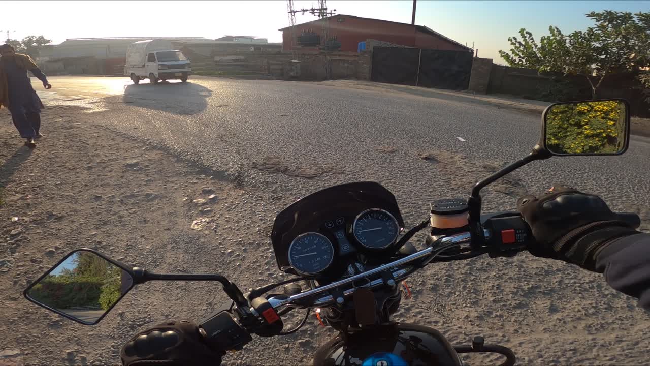 A Pakistani motorcyclist riding through his city