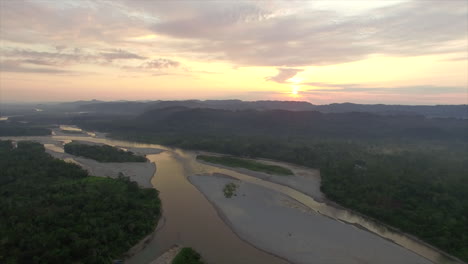 golden yellow sunrise on horizon over amazon rainforest