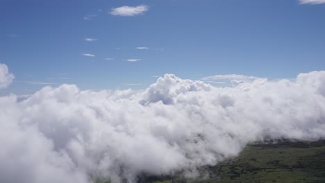 Drone-flight-over-low-fluffy-white-clouds-on-Pico-Island