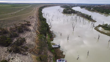 drone shot of a flooded muddy river in the south australian riverland