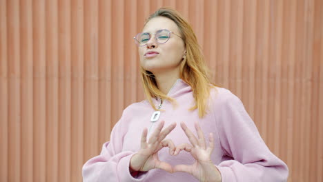 mujer haciendo forma de corazón con las manos