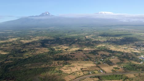 aerial drone view over fields and forest, towards mount kilimanjaro, on the countryside of east africa