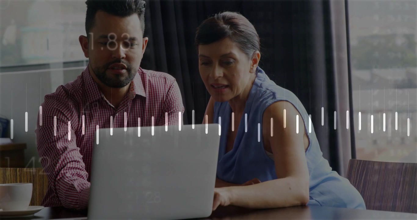 Vertical video: Duo leaning in on data update, gesturing as laptop waveform animating business data