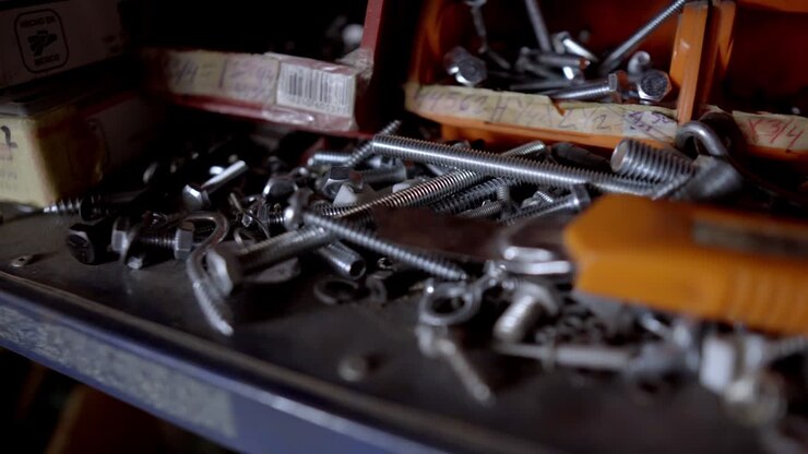 Close-up of Metal Fasteners and Tools on a Workshop Shelf