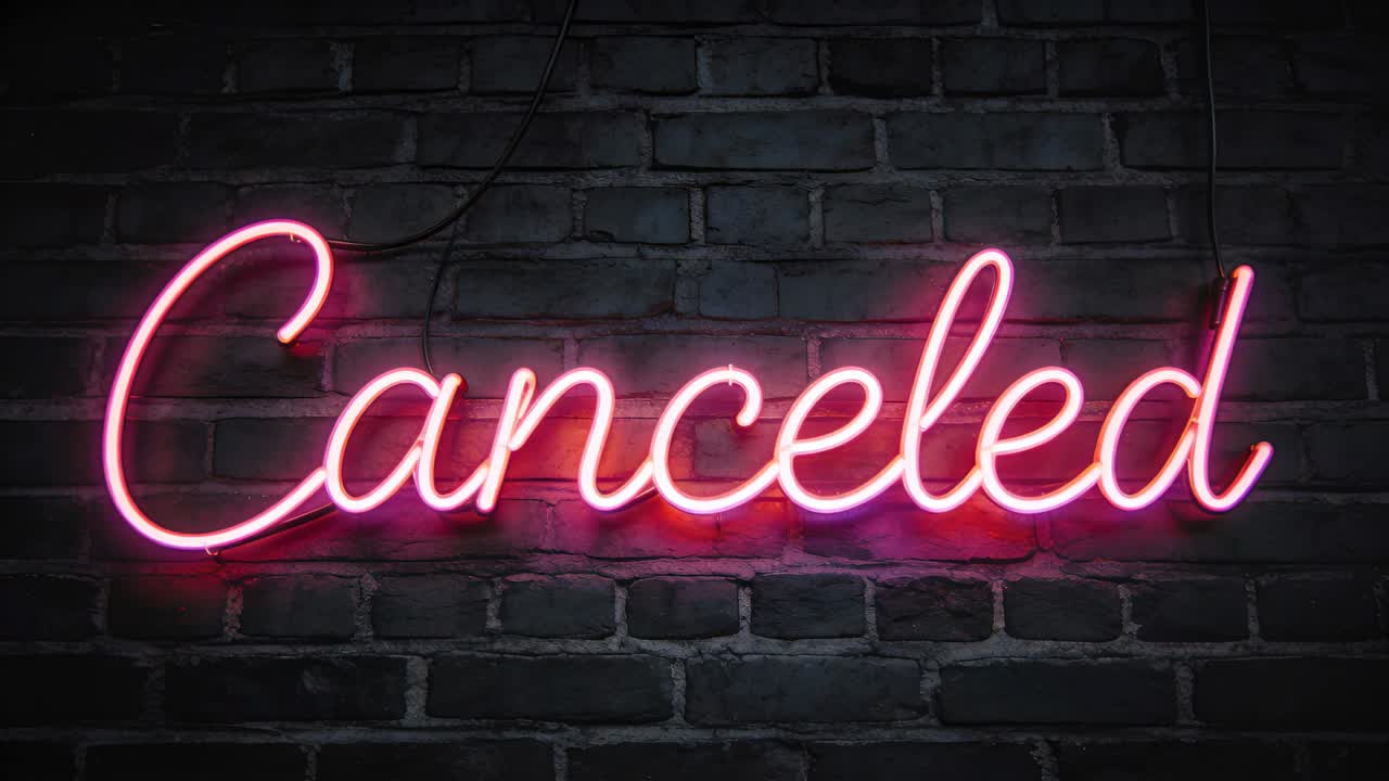 Power cable powering neon sign reading Canceled pulsing pink halo on brick wall in bar