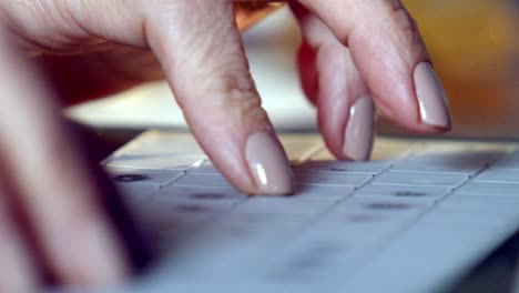 woman's fingers typing on a keyboard - isolated close up