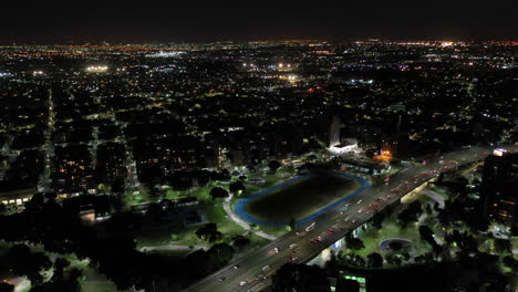 Moving-aerial-shot-at-night-of-the-city-of-Buenos-Aires-with-buildings-and-street-with-traffic