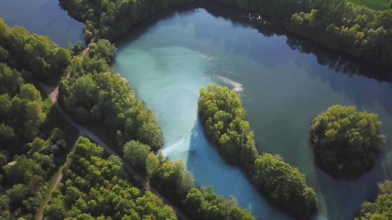 aerial orbit view in Bochum Werne, Germany nature with water reflections by the sun